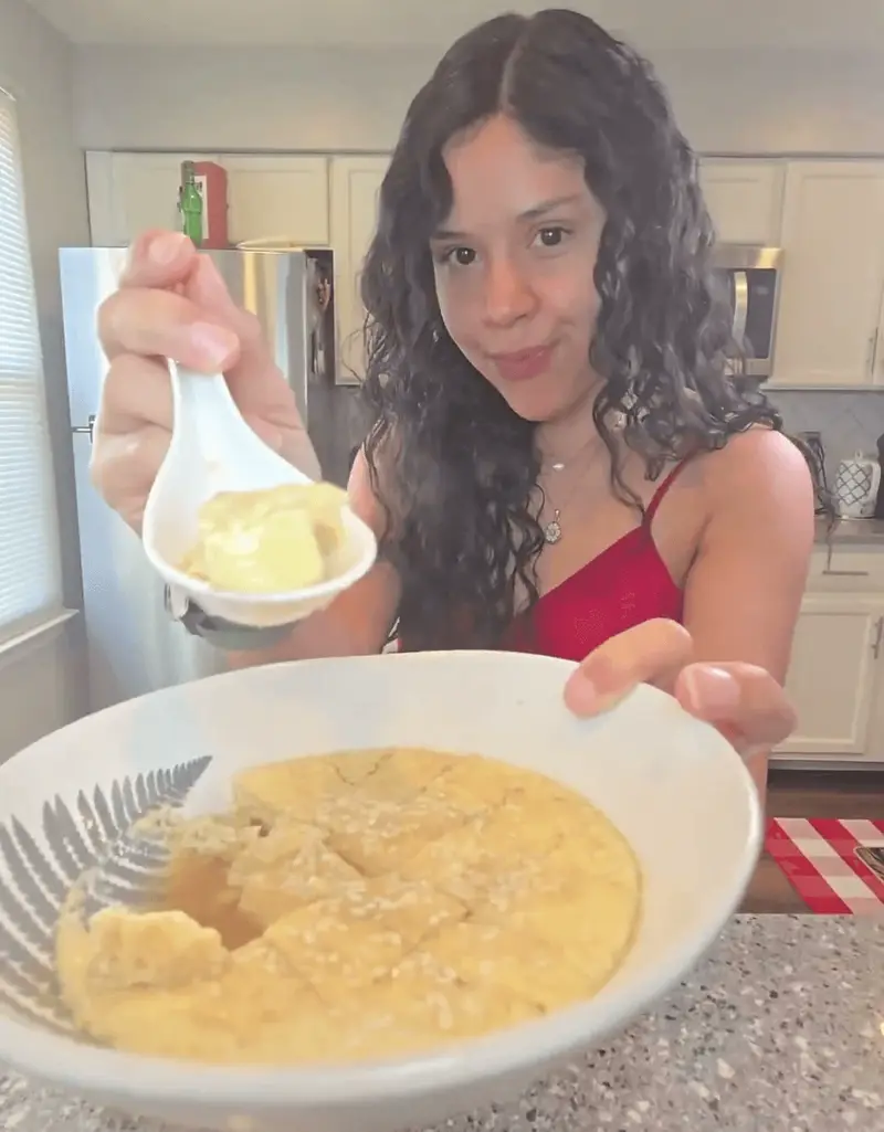 Crystal lifting a spoonful of silky steamed egg custard out of the bowl