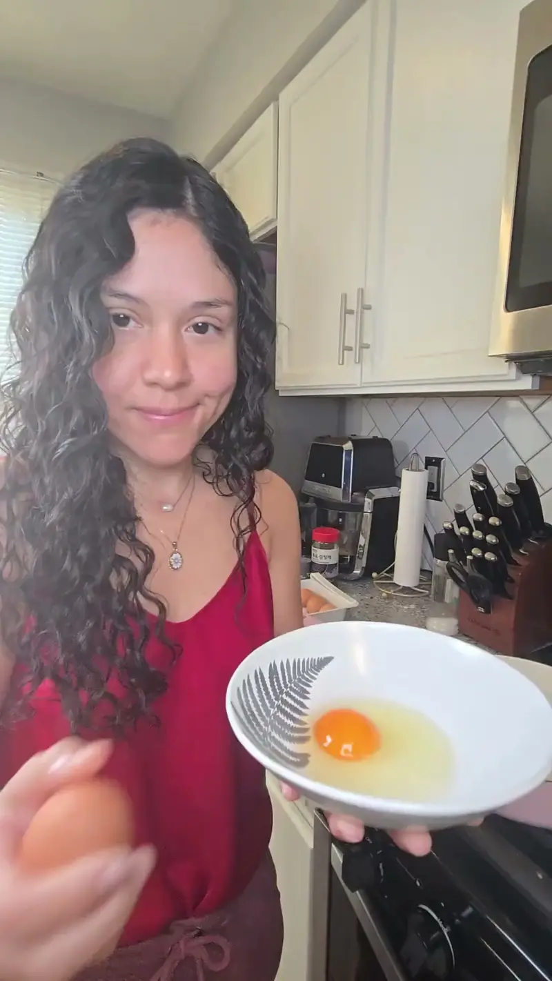 Crystal cracking an egg into a patterned bowl