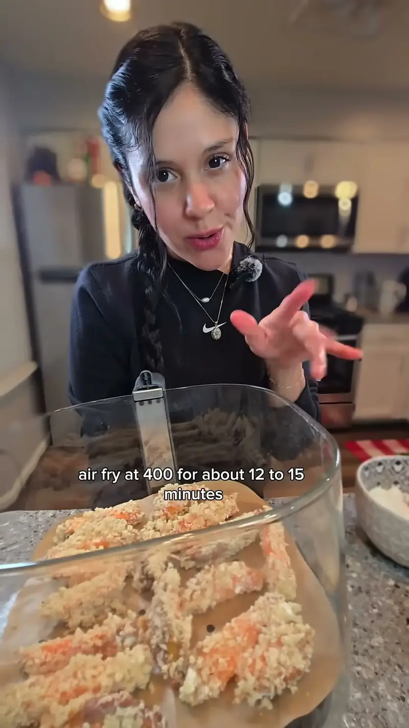 Crystal explaining the air fryer setting over a basket of battered sweet potato tempura