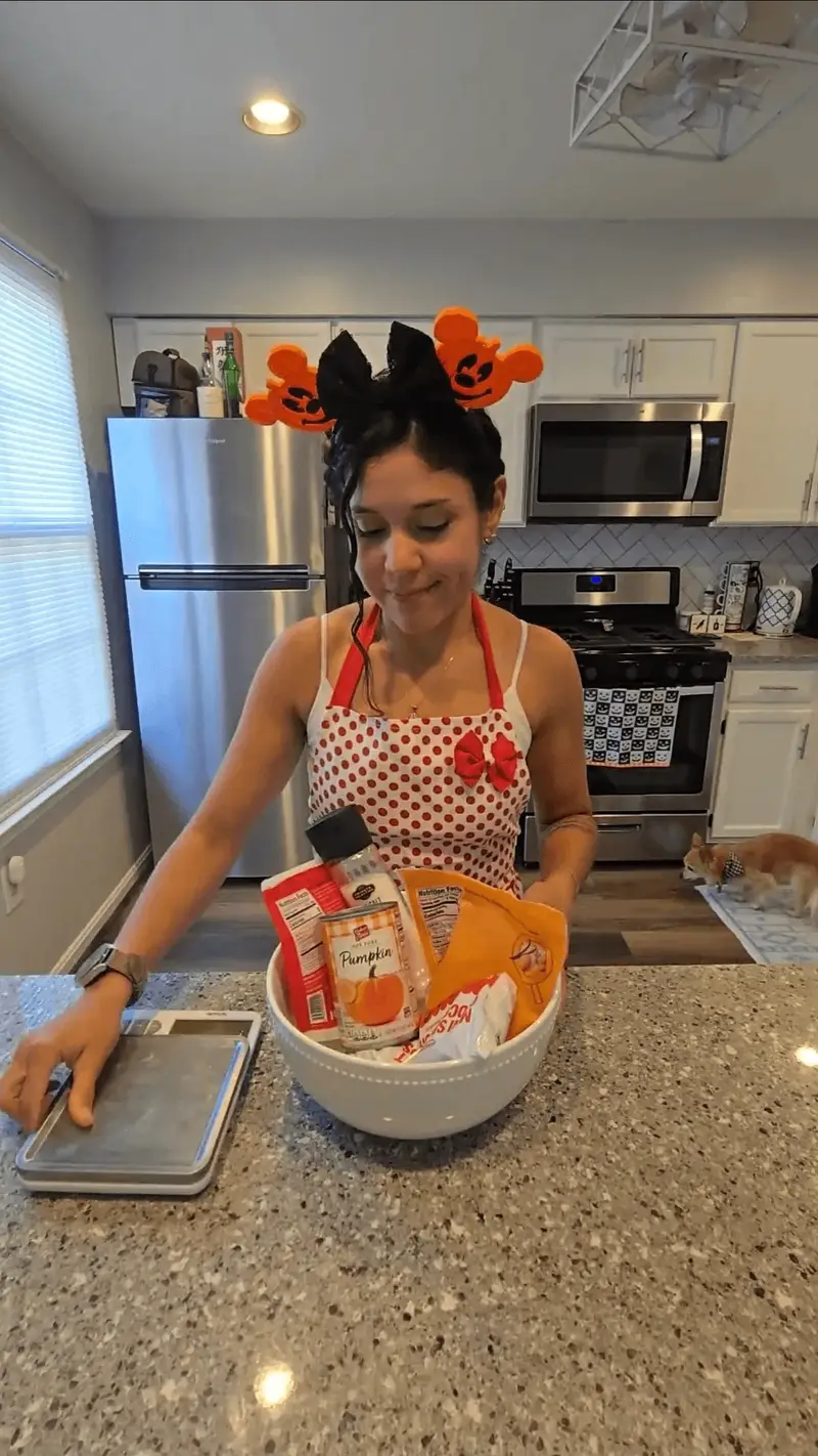 Crystal gathering the pumpkin cake pop ingredients into a mixing bowl