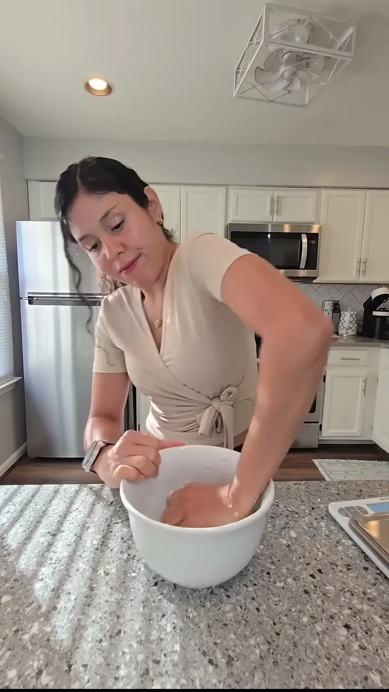 Crystal stirring Greek yogurt and flour together in a white bowl