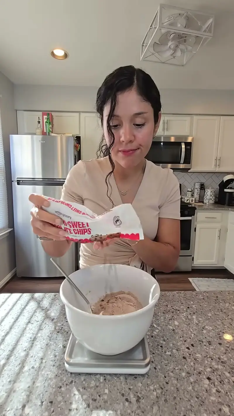 Crystal weighing the bagel dough on a kitchen scale