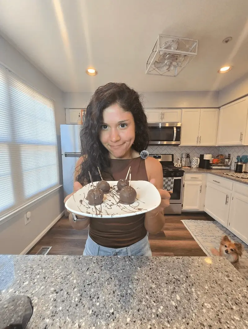 Crystal holding a plate of peanut butter chocolate truffles