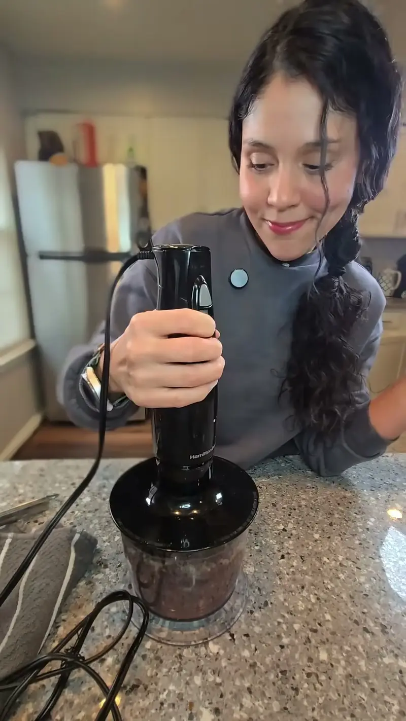 Crystal blending the black bean mixture with an immersion blender