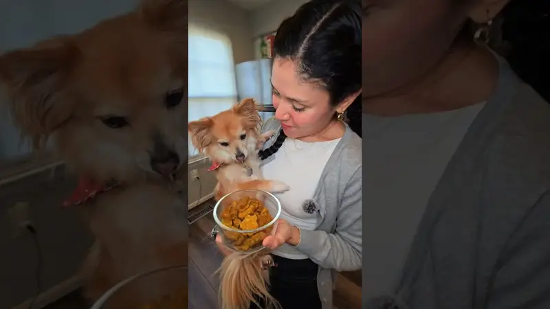 Crystal holding her dog in one arm and a bowl of homemade dog treats in the other