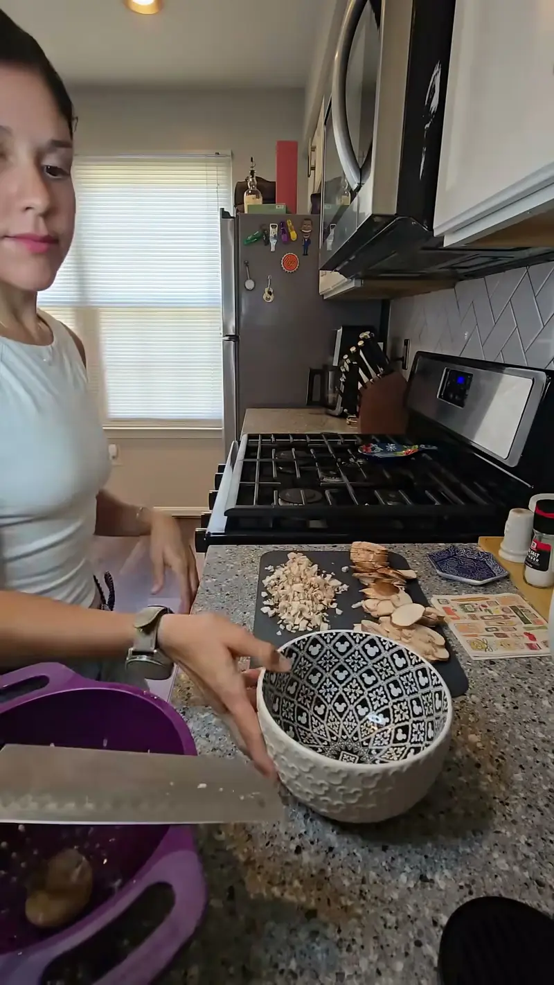 Crystal slicing mushrooms beside a bowl of the ravioli filling