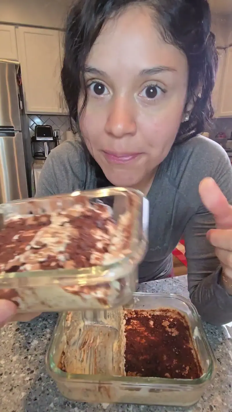 Crystal holding a glass dish of chia seed tiramisu dusted with cocoa