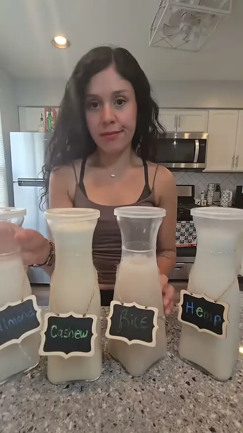 Crystal behind four carafes of plant milk labelled almond, cashew, rice and hemp