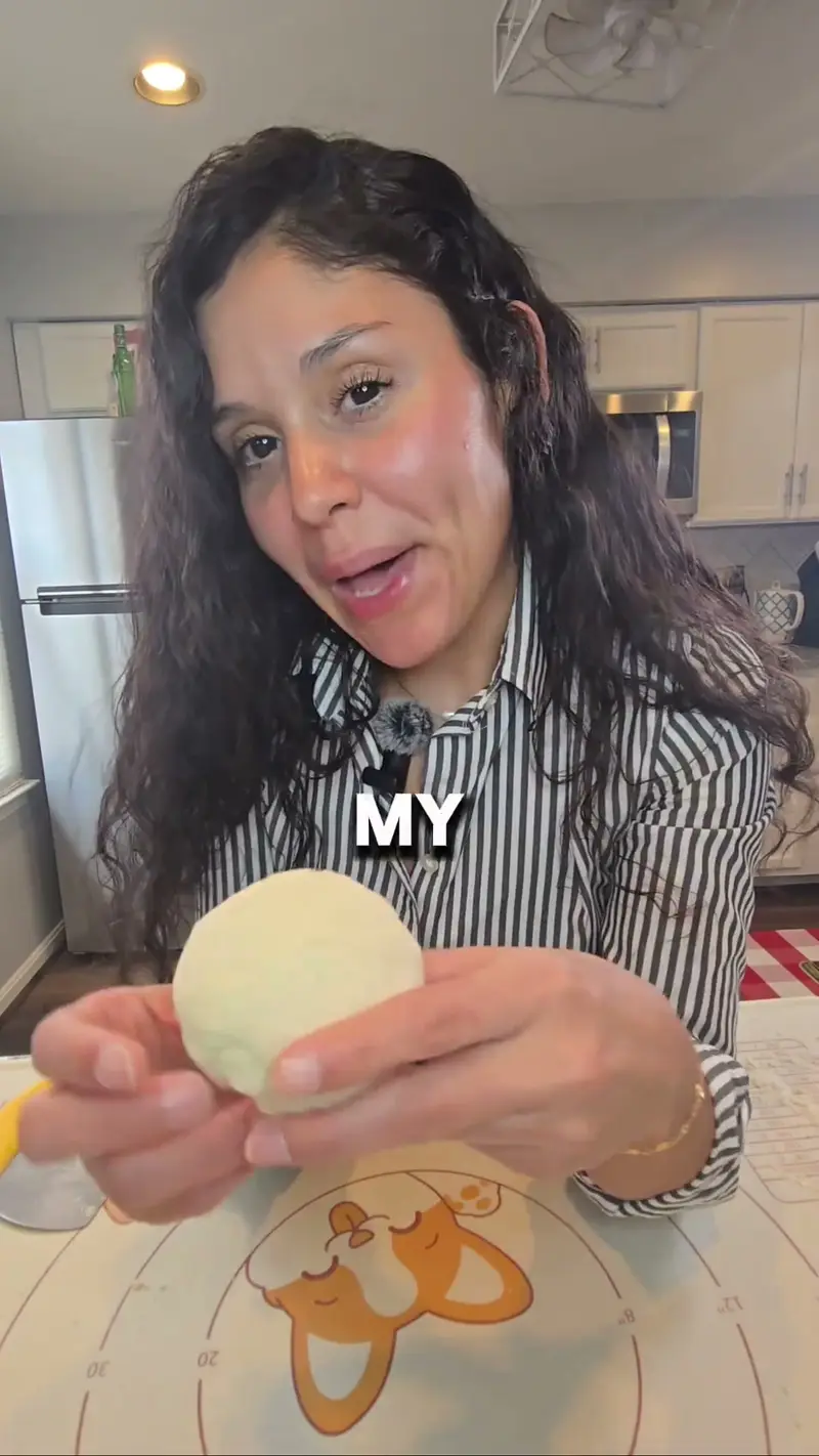 Crystal holding up the ball of two-ingredient pasta dough