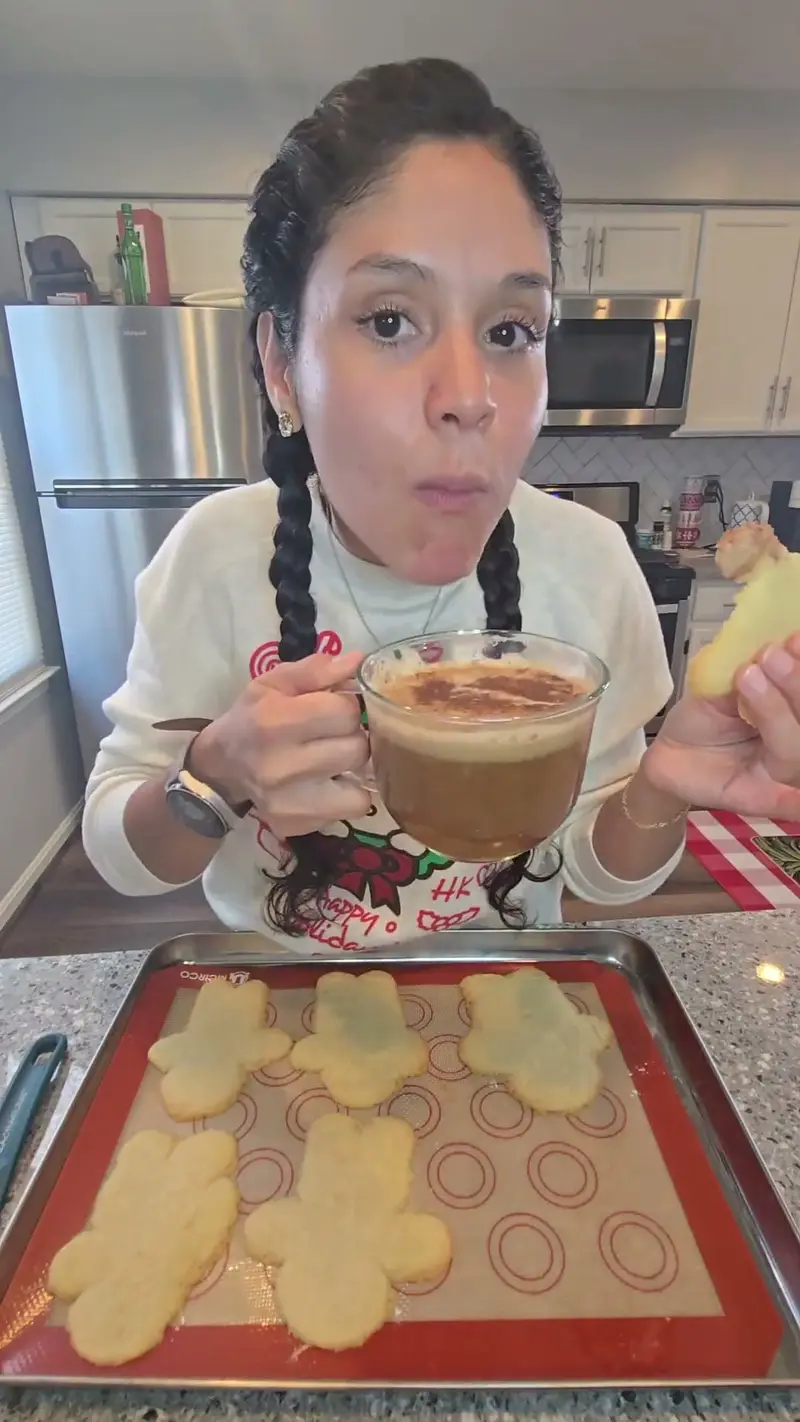 Crystal with a mug beside a tray of gingerbread-shaped shortbread
