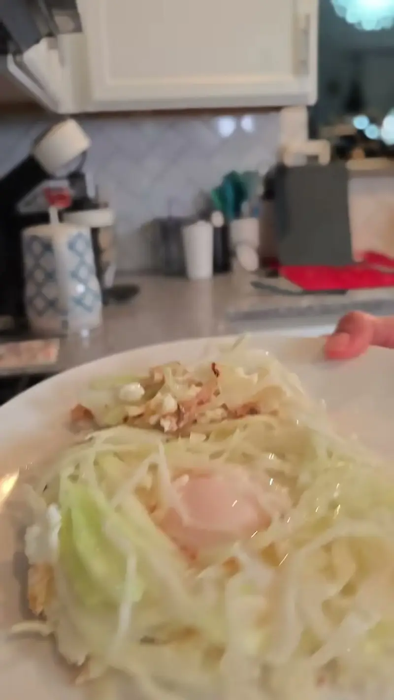 A close-up of the cabbage noodle bowl with a soft egg on top