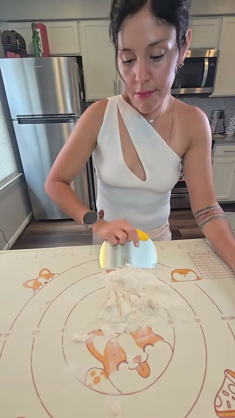 Crystal scooping ricotta filling onto a sheet of pasta dough